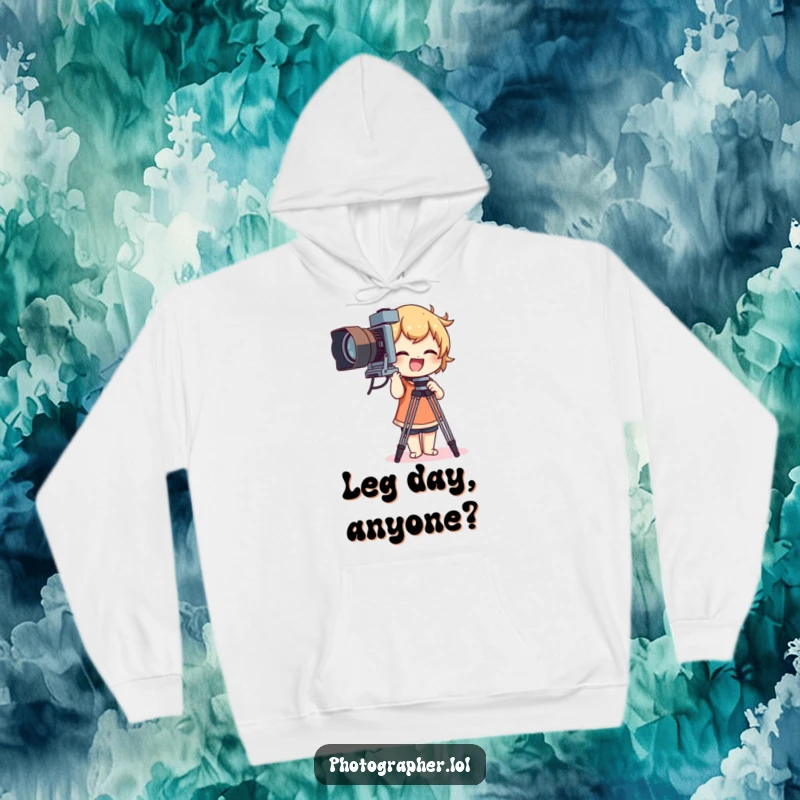Funny hoodie depicting a character gleefully adjusting a large vintage camera tripod, showcasing photography fun.