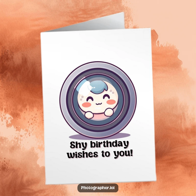 Funny free printable birthday card: a round, blushing character peeks shyly from behind a giant camera lens, a sweet birthday greeting.